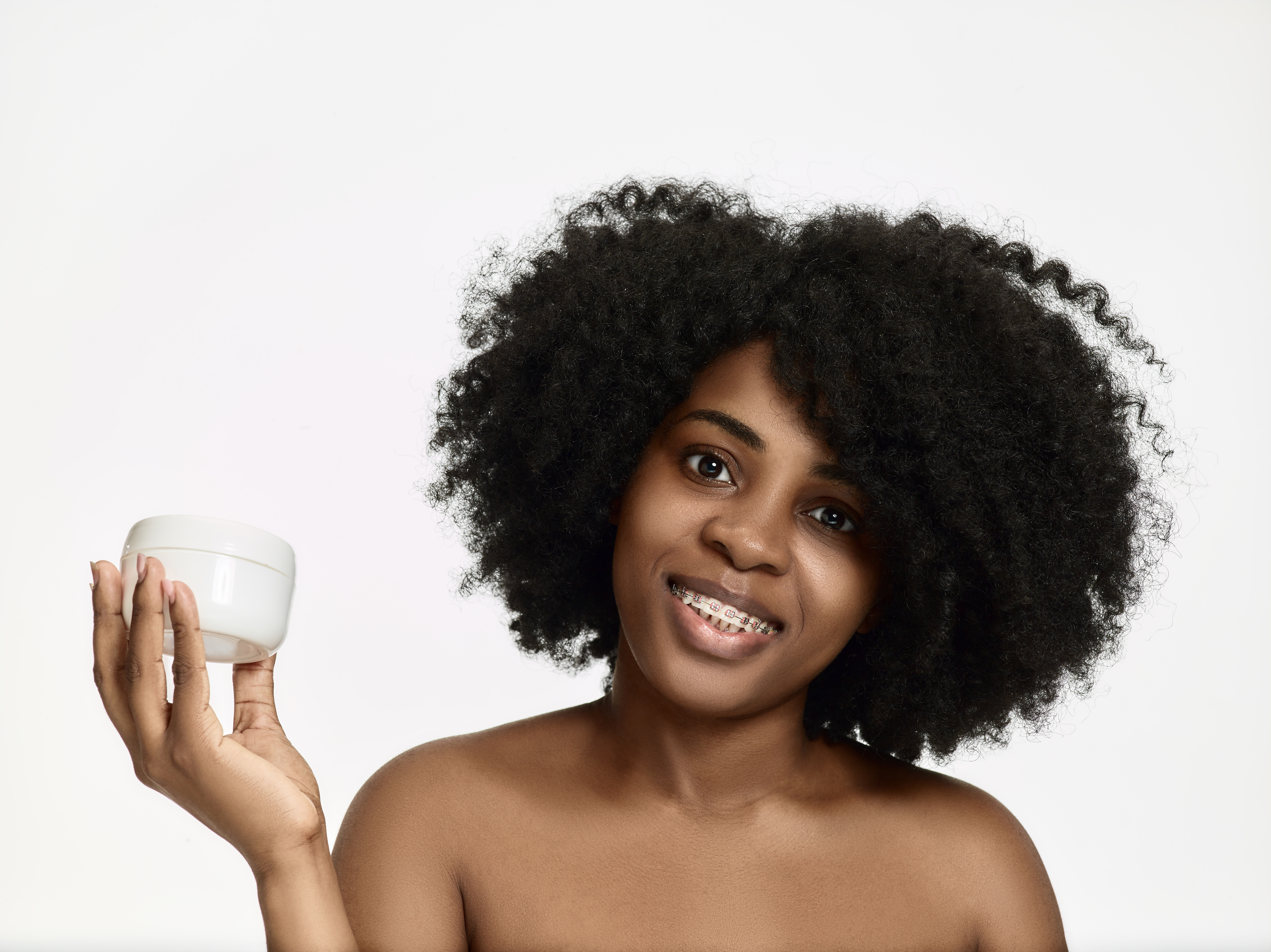 portrait young smiling woman holding moisturise container