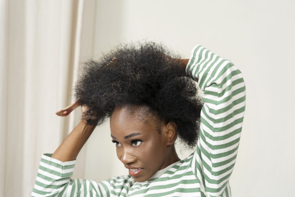 side view woman combing hair 1