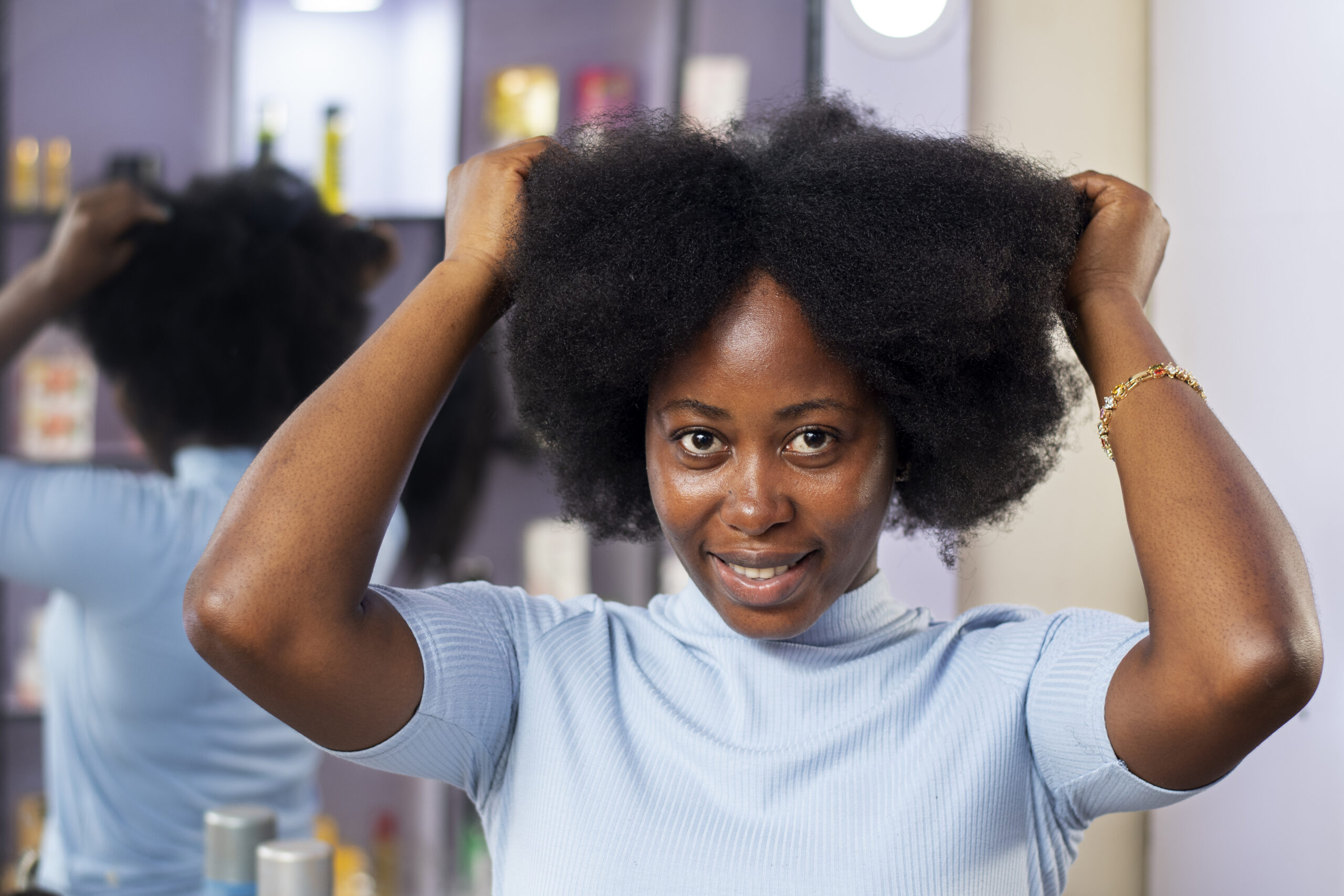 woman taking care her afro hair 1 scaled
